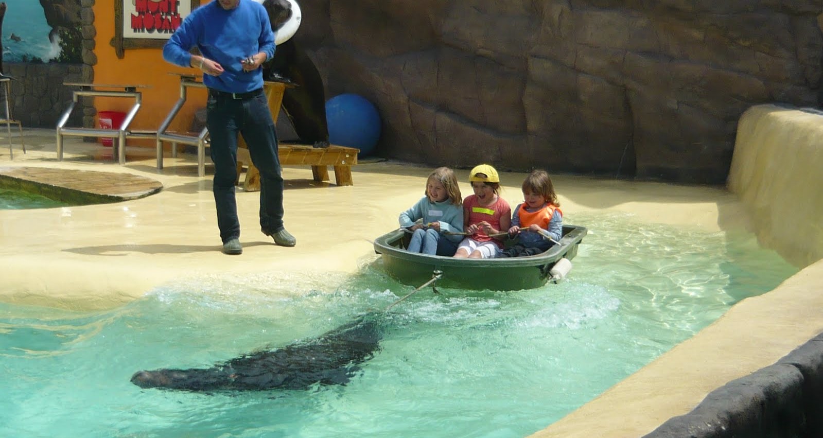 A sea lion pulls kids in a boat at Mont Mosan